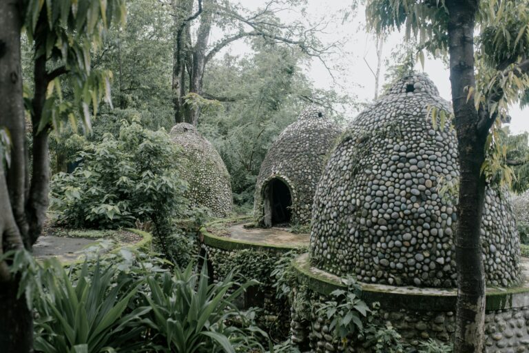 Exterior of aged stone meditation caves located on territory of Beatles Ashram in lush green tropical garden in India